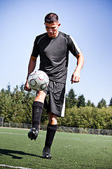 Image showing Hispanic soccer or football player kicking a ball