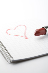 Image showing Lipstick and heart on notepad.