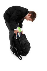 Image showing School boy packing school bag