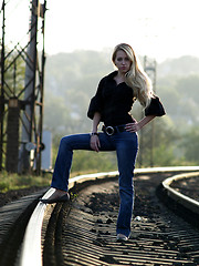 Image showing Young woman staying on railway