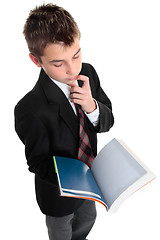 Image showing Student pindering thinking with open text book