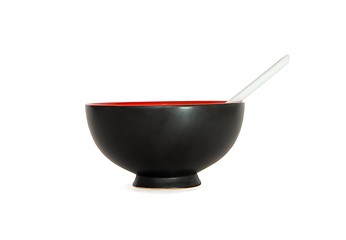 Image showing Black Japanese bowl with white spoon side view isolated