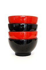 Image showing Stack of two red and two black porcelain bowls isolated