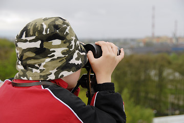 Image showing boy observing nature through binoculars