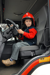 Image showing boy is sitting in a fire truck