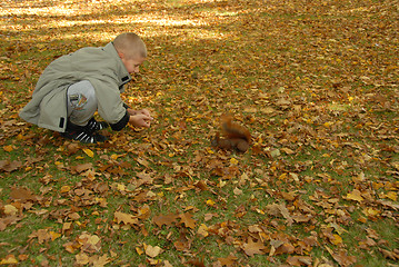 Image showing teen boy and red squirrel