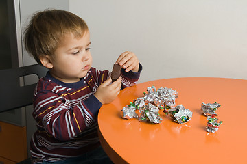 Image showing Boy eating chocolates