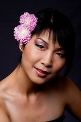 Image showing Face of Asian woman with flowers