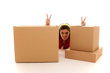 Image showing Happy woman behind the boxes