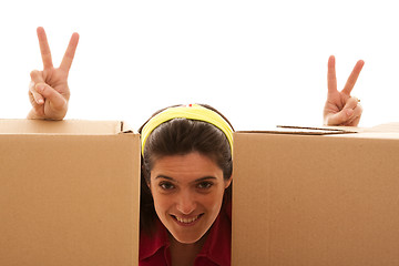 Image showing Happy woman behind the boxes