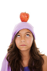 Image showing young child with an apple on her head