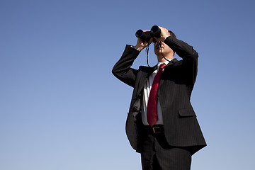 Image showing Businessman looking through binoculars