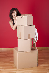 Image showing Woman holding cardboard boxes