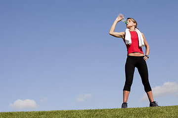 Image showing woman refreshing after the exercise