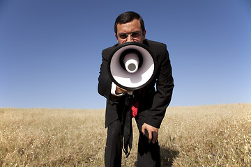 Image showing Businessman shouting at the megaphone to you