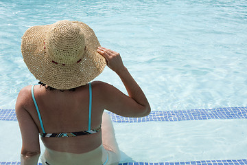 Image showing woman relaxing at the pool