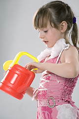 Image showing Girl with a toy watering can