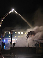 Image showing Firefighters putting out fire on house