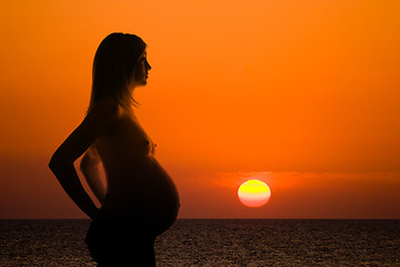 Image showing pregnant woman silhouette on sea sunset