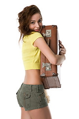 Image showing girl hugs a suitcase with a smile