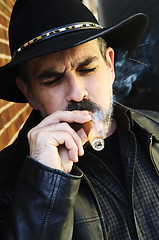 Image showing Bearded man smoking cigar