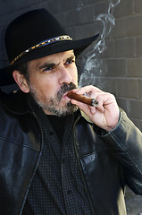 Image showing Bearded man smoking cigar