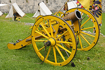 Image showing Yellow cannon and flag