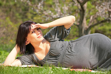 Image showing expectant mother reposes in town park