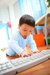 Image showing little boy with keyboard, soft focus