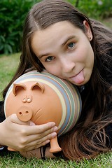 Image showing Girl with piggy