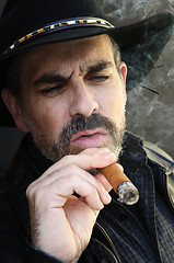 Image showing Bearded man smoking cigar