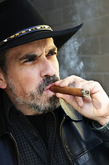 Image showing Bearded man smoking cigar