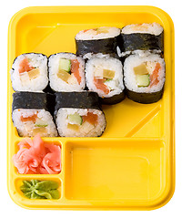 Image showing Yellow plate with rolls of sushi