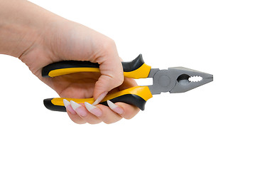 Image showing Female hand hold black and yellow pliers