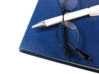 Image showing  Notebook,ball-pen and glasses over white background