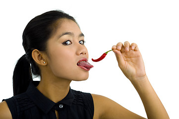 Image showing woman licking hot chili pepper