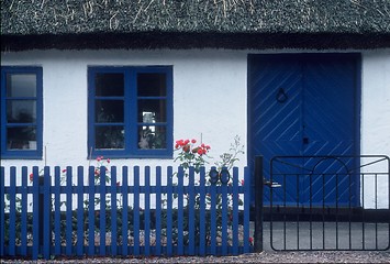 Image showing Small house with blue windows and blue rails