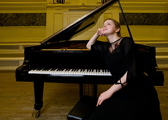 Image showing Dreamy smiling pianist