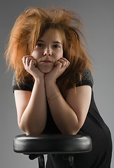 Image showing beautiful girl leaned one's elbows on a chair