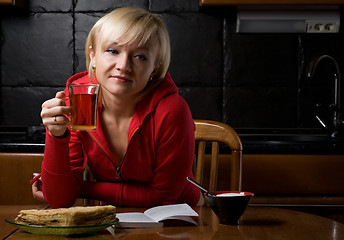 Image showing girl with a book in a cafe