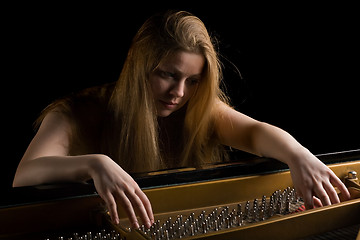 Image showing Girl behind a grand piano