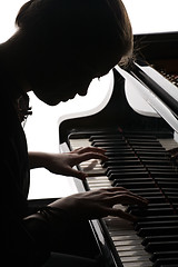 Image showing beautiful girl playing the piano