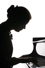 Image showing beautiful girl playing the piano