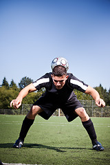 Image showing Hispanic soccer or football player kicking a ball