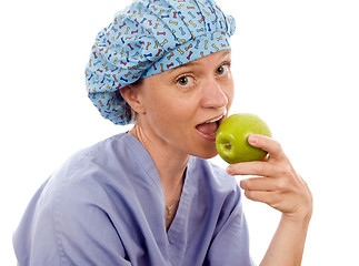 Image showing nurse medical person eating granny smith apple