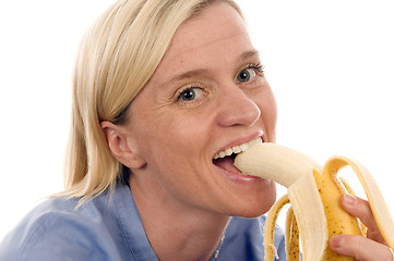 Image showing nurse medical person eating banana