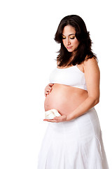 Image showing Pregnant woman holding baby shoes