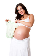 Image showing Pregnant woman holding baby bodysuit