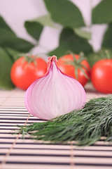 Image showing Onions with fennel against a tomato