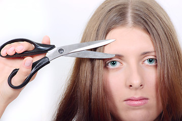 Image showing The nice girl with scissors
